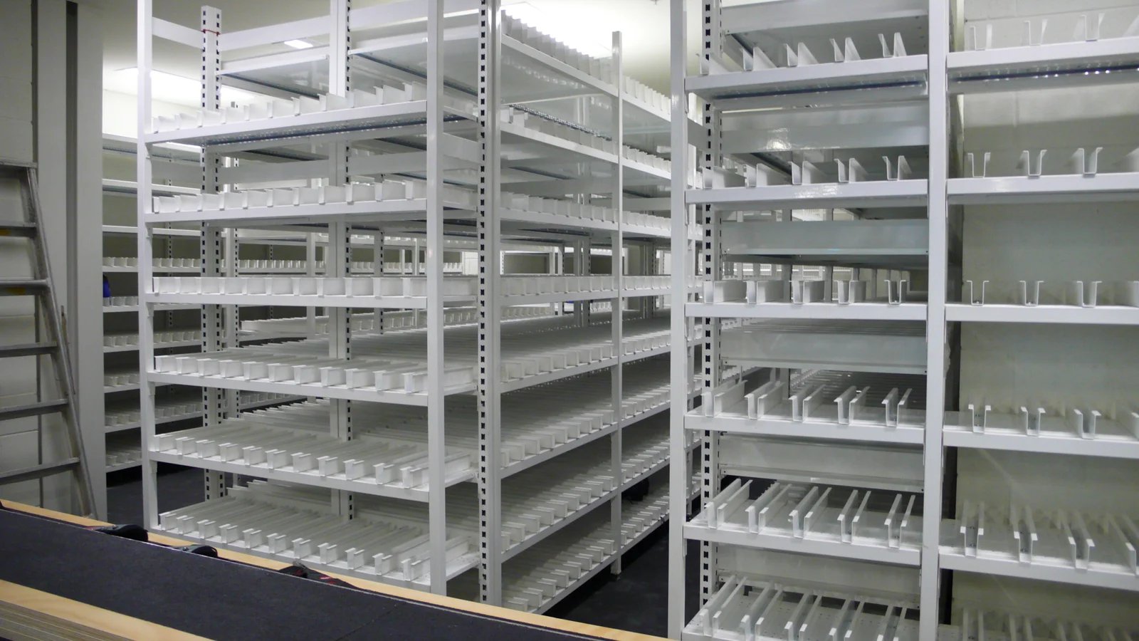 Rows of white metal shelves